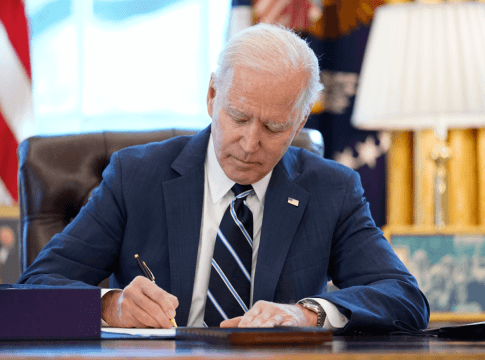 President Joe Biden signs the American Rescue Plan, a coronavirus relief package, in the Oval Office of the White House, Thursday, March 11, 2021.