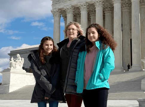 Montana resident Kendra Espinoza poses in front of the white-marble court building with her daughters Naomi (right) and Sarah (left) in Washington, D.C., on January 19, 2020.